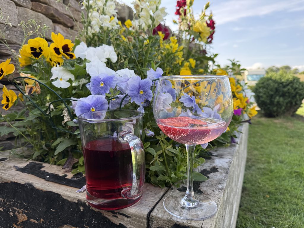 Drinks next to flowers in the seating area.